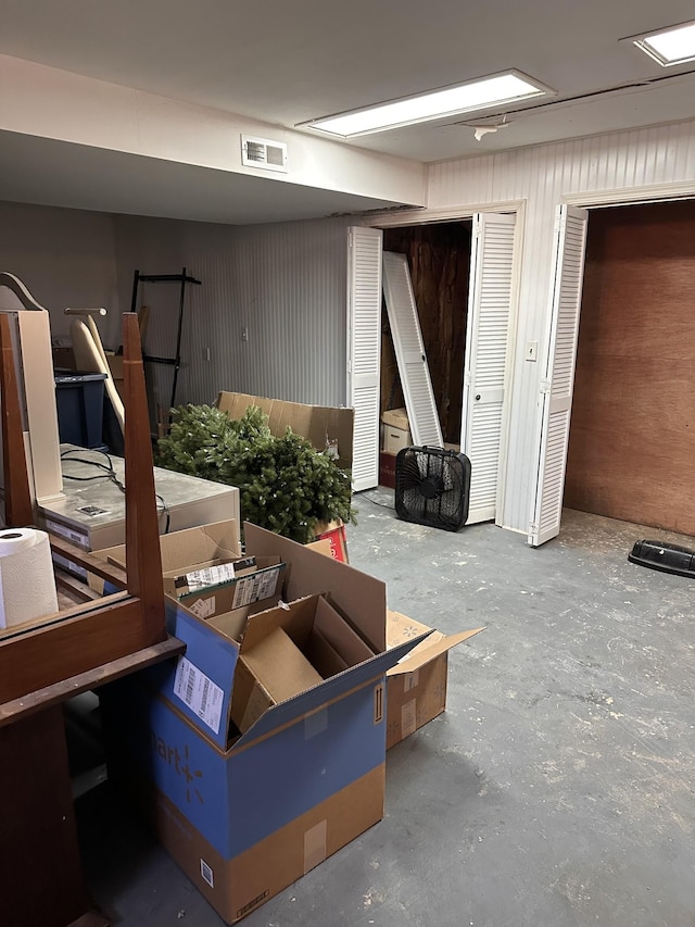 basement featuring wood walls