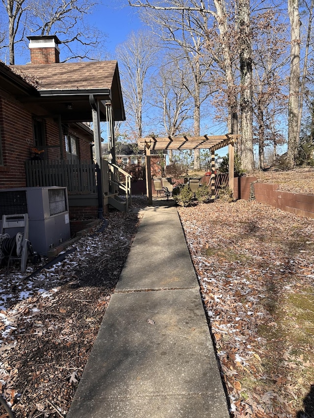 view of yard with a pergola and cooling unit