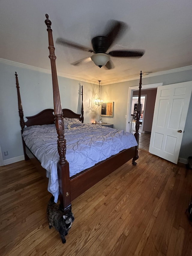 bedroom featuring ceiling fan, wood-type flooring, and ornamental molding