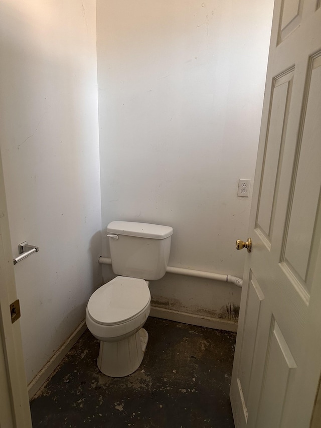 bathroom featuring toilet and concrete flooring