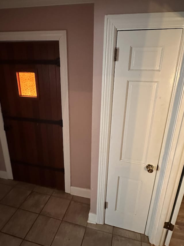 hall with tile patterned floors