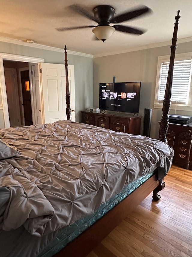 bedroom featuring ceiling fan, light wood-type flooring, and crown molding