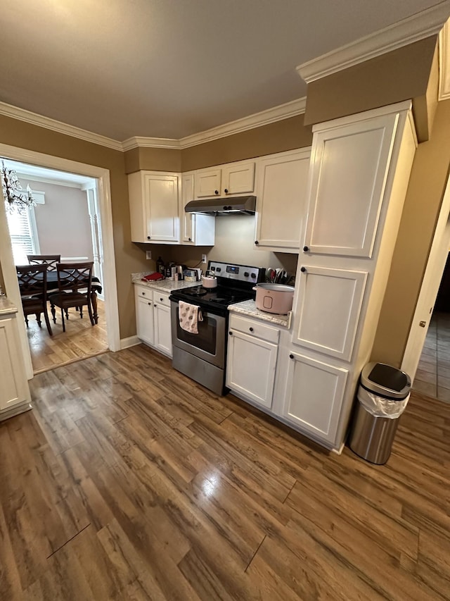 kitchen with dark wood-type flooring, electric range, crown molding, and white cabinetry