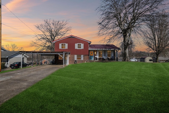 split level home with a porch, a yard, and a carport