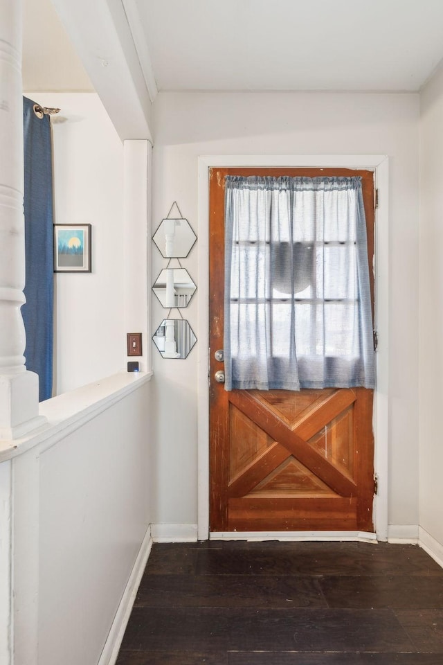 entryway with dark hardwood / wood-style flooring