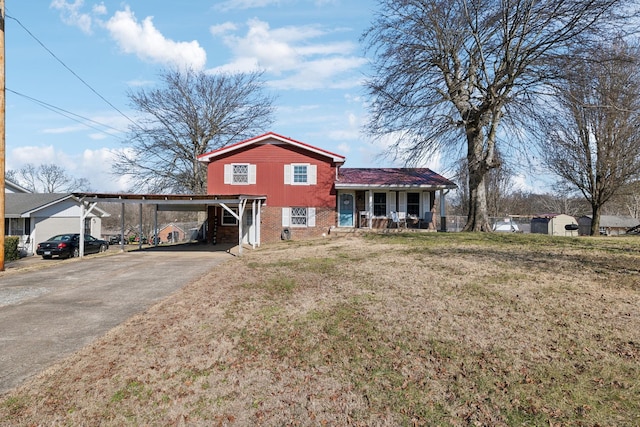 view of front of home with a front yard, a carport, and a porch