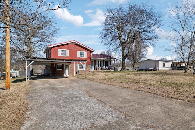 view of front facade with a front lawn and a carport