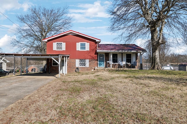 view of front of property with a carport, a front yard, and covered porch