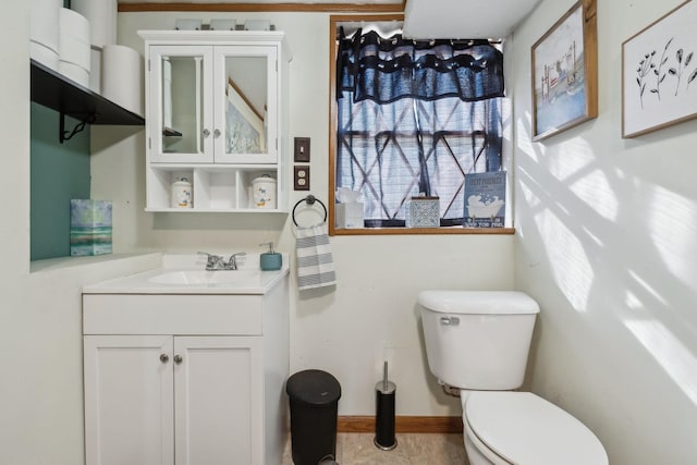 bathroom with vanity, toilet, and a healthy amount of sunlight