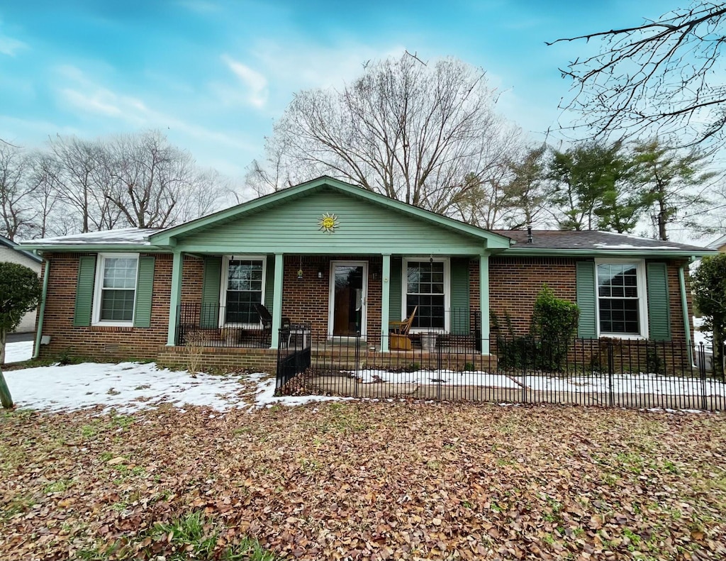 single story home featuring covered porch