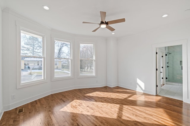 empty room featuring ceiling fan, crown molding, and light hardwood / wood-style flooring