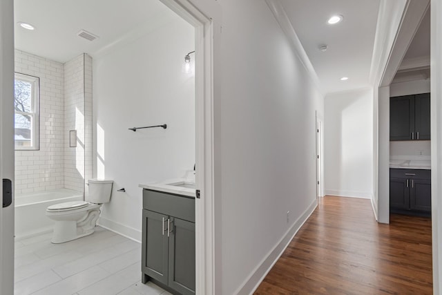 full bathroom with toilet, vanity, crown molding, and tiled shower / bath combo