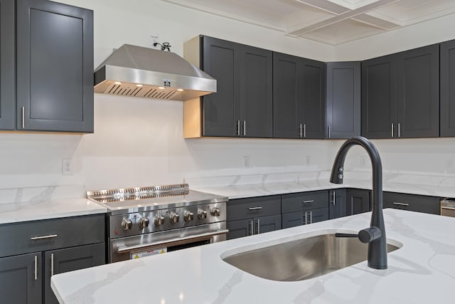 kitchen featuring high end stainless steel range oven, light stone counters, and extractor fan