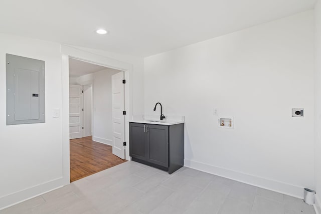 clothes washing area with cabinets, washer hookup, sink, hookup for an electric dryer, and electric panel