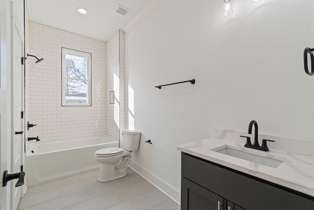 full bathroom featuring tiled shower / bath combo, vanity, toilet, and tile patterned flooring