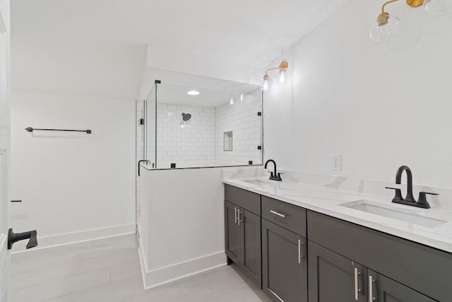 bathroom with walk in shower, vanity, and tile patterned floors