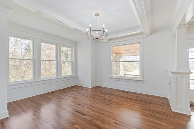 unfurnished dining area with dark wood-type flooring, ornamental molding, and a chandelier