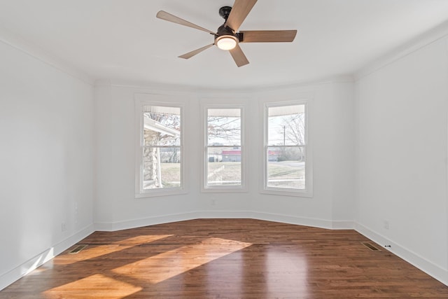 spare room featuring ceiling fan, dark hardwood / wood-style floors, and ornamental molding