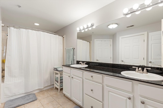 bathroom featuring shower / tub combo, tile patterned floors, and vanity