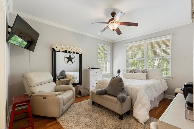 bedroom with ceiling fan, crown molding, and hardwood / wood-style flooring