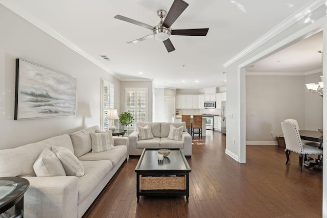 living room with dark hardwood / wood-style flooring, crown molding, and ceiling fan with notable chandelier