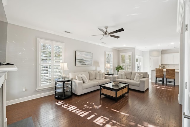 living room with ceiling fan, ornamental molding, and dark hardwood / wood-style floors