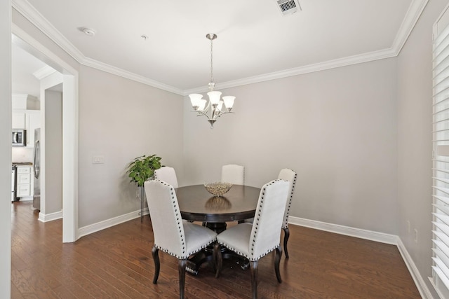 dining space with crown molding, dark hardwood / wood-style floors, and a chandelier