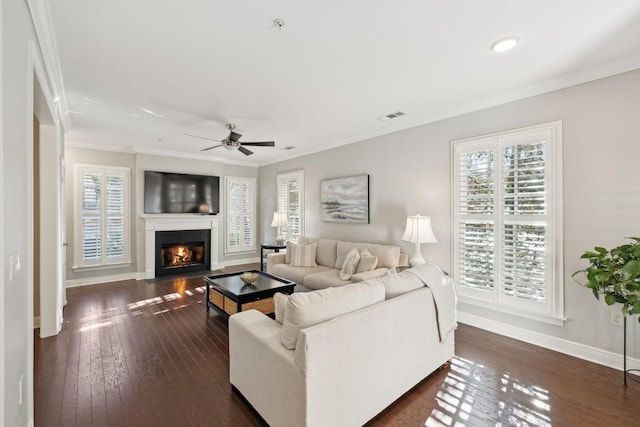 living room with crown molding, dark hardwood / wood-style floors, and ceiling fan