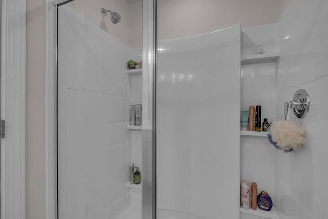 bathroom featuring a shower with door