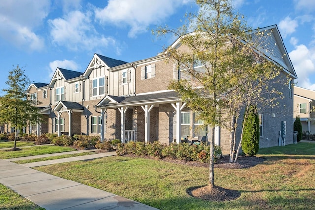 view of property with a front lawn and a porch