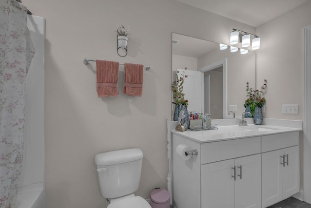 bathroom featuring toilet and vanity