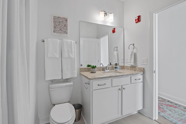 bathroom with toilet and vanity