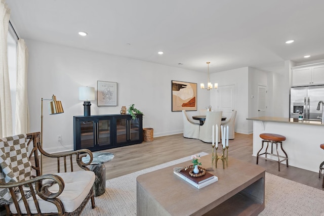 living room featuring light hardwood / wood-style flooring and a chandelier