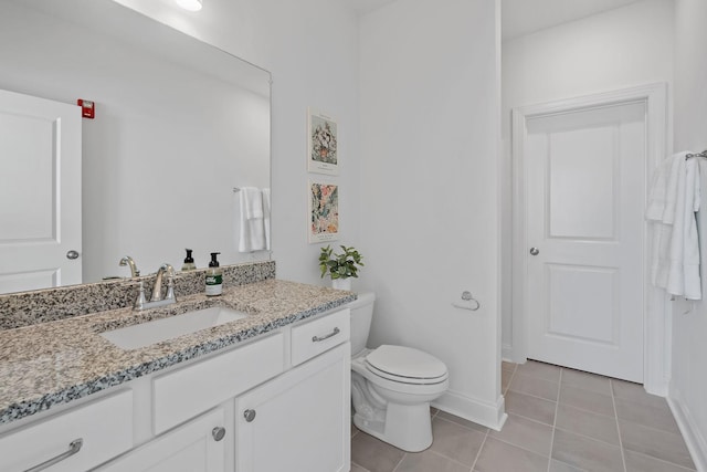 bathroom with tile patterned floors, vanity, and toilet