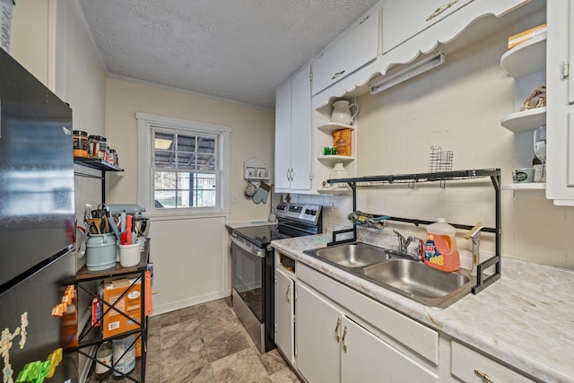 kitchen with electric stove, refrigerator, sink, and white cabinetry