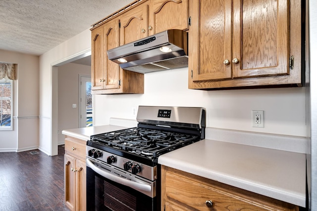 kitchen featuring stainless steel gas range oven, a wealth of natural light, dark hardwood / wood-style flooring, and a textured ceiling