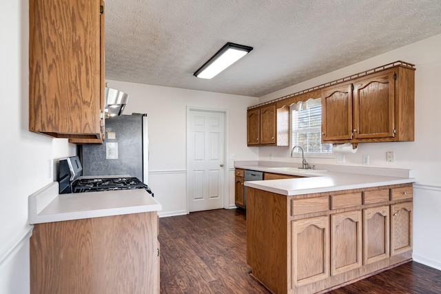 kitchen featuring backsplash, stove, sink, a textured ceiling, and dark hardwood / wood-style flooring