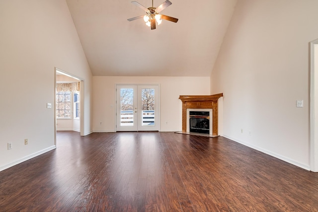 unfurnished living room featuring ceiling fan, french doors, dark wood-type flooring, and high vaulted ceiling