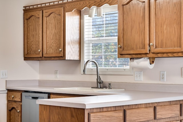 kitchen with stainless steel dishwasher, plenty of natural light, and sink