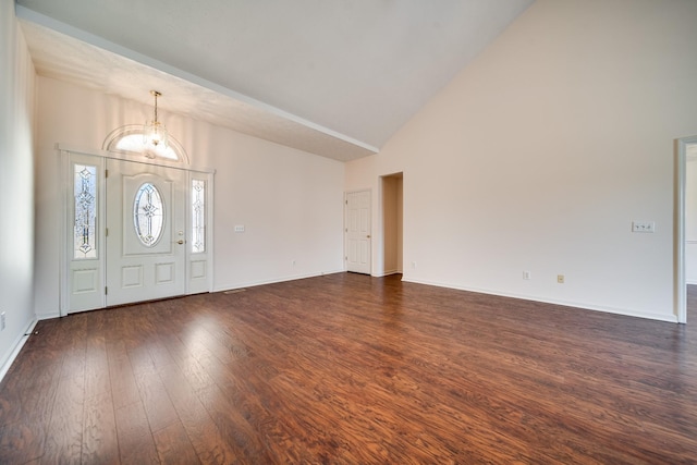 entryway with high vaulted ceiling, dark hardwood / wood-style floors, and a chandelier