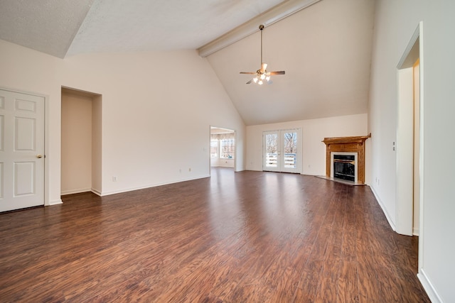 unfurnished living room with dark wood-type flooring, french doors, high vaulted ceiling, ceiling fan, and beam ceiling