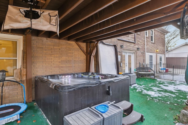 view of patio / terrace featuring french doors and a hot tub