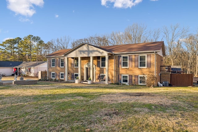 view of front of home featuring central AC and a front yard