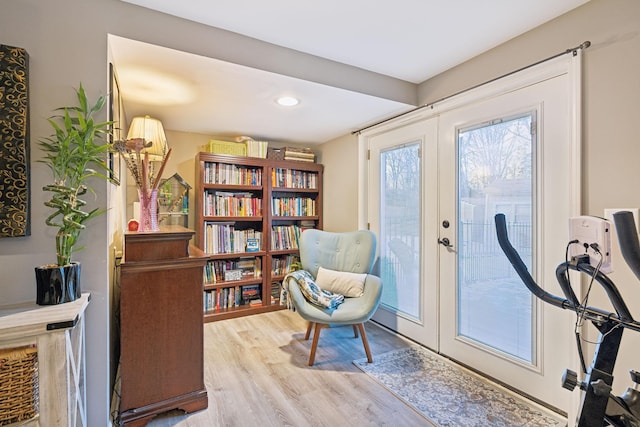 sitting room with light hardwood / wood-style flooring and french doors