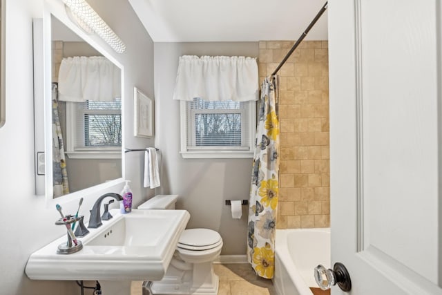 full bathroom featuring sink, tile patterned floors, toilet, and shower / tub combo