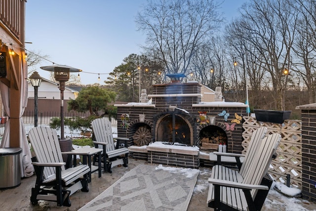 view of patio featuring an outdoor brick fireplace