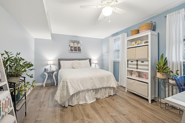 bedroom with ceiling fan and hardwood / wood-style flooring