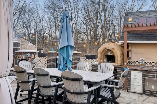 view of patio with an outdoor fireplace