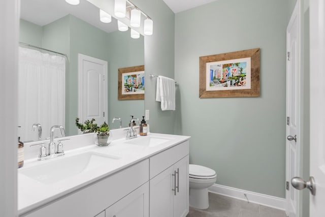 bathroom featuring tile patterned floors, vanity, and toilet