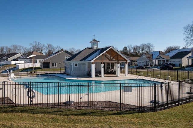 view of pool with a lawn and a patio